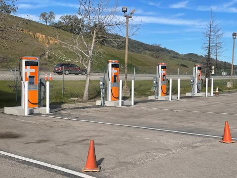 Photo of four bus chargers in a parking lot